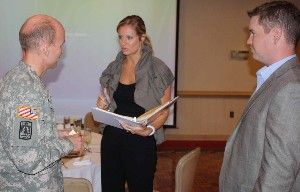 At the chapter's August luncheon, members of Atlanta's communication industry discuss solutions with Col. Barlow (l).